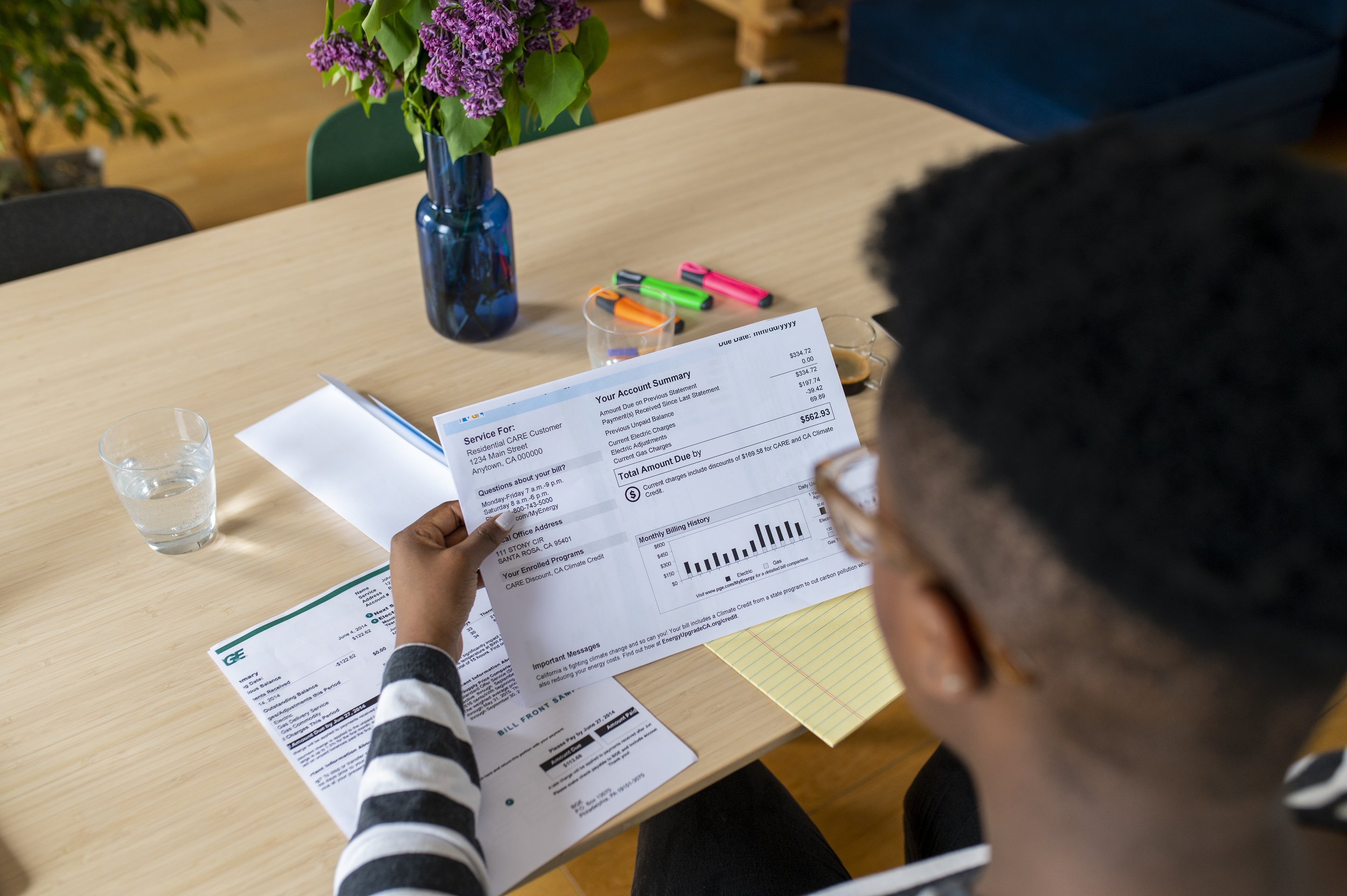A young African American man looks at the electricity bill